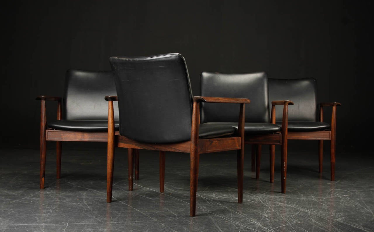 This set of four Diplomat chairs designed by Finn Juhl for France & Daverkosen is made of the most exceptional rosewood and retains the original black leather in excellent condition.