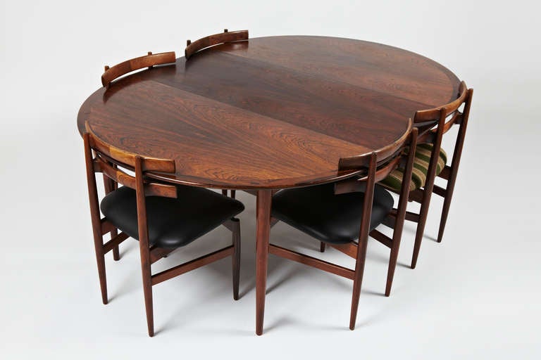 This listing is for a fortuitously well matched dining set consisting of a round rosewood dining table with 2 extension leaves and 8 dining chairs. The 72cm height of the dining table designed by Grete Jalk and made by P. Jeppsen positions the two