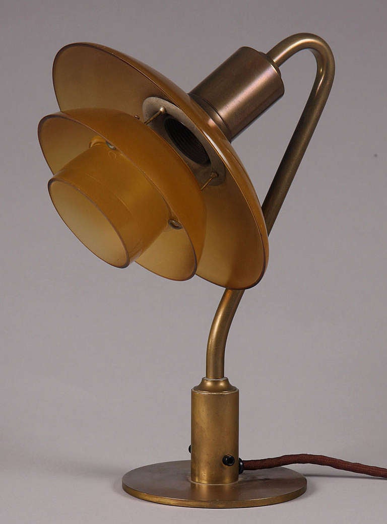 This listing is for a Poul Henningsen desk lamp designed by Poul Henningsen and made by Louis Poulsen during 1931-33. Amazingly, the original amber color shades are in perfect condition without chips or scratches.