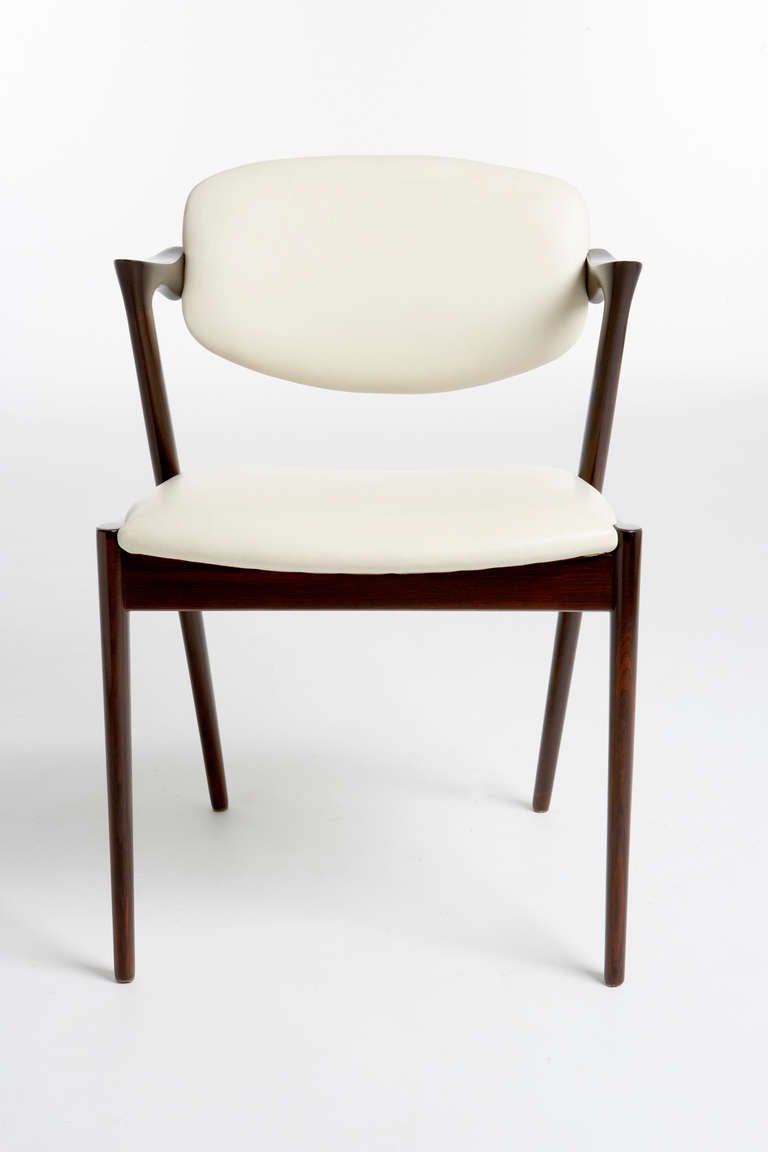 Kai Kristiansen's dining chairs designed in 1957 are still chic today. Paere Dansk sells these chairs in a variety of wood types from a variety of periods but this listing is for up to 18 chairs made of rosewood between 1957 and 1970. These 1950-60s