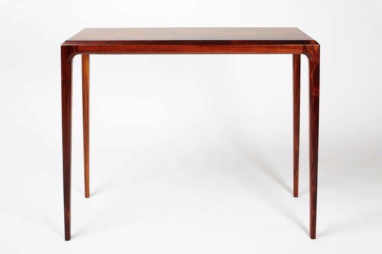 Simple and elegant, this PD60 console table is made by hand in Denmark of solid rosewood. In 2006, Paere Dansk visited Costa Rica to source sustainable rosewood, where a reforestation expert has committed 20 years of his life to buying up uneconomic