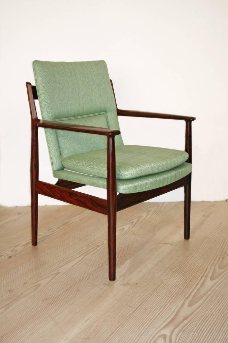 Sixteen (16) of these rosewood chairs in light green wool are available as a set or individually. All made and labelled by Sibast, the condition of the herringbone fabric suggests these chairs were perhaps reupholstered about the year 2000. The