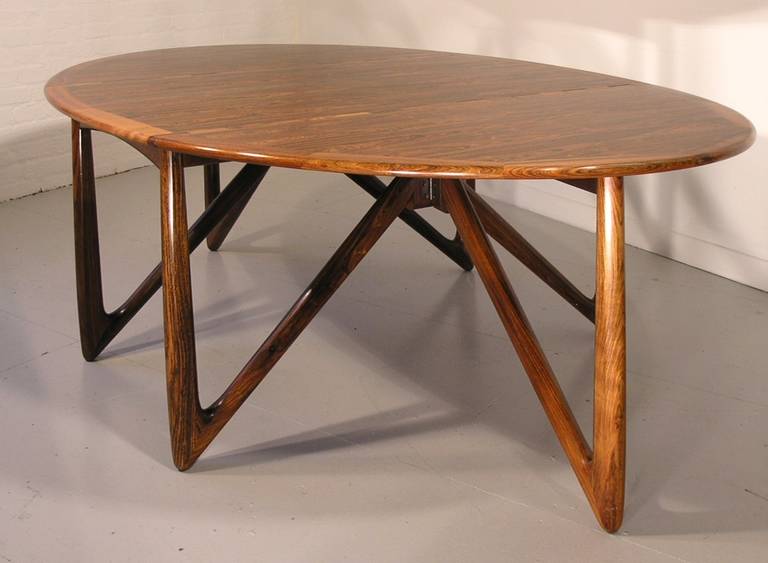 Often ascribed to Kurt Ostervig and/or Jason Mobler, this table was designed in 1964 by Niels Kofoed in Hornslet, Denmark. Niels Kofoed and his brother Peter Kofoed were a team who designed and made Danish rosewood furniture in the 1960s. Kofoed,