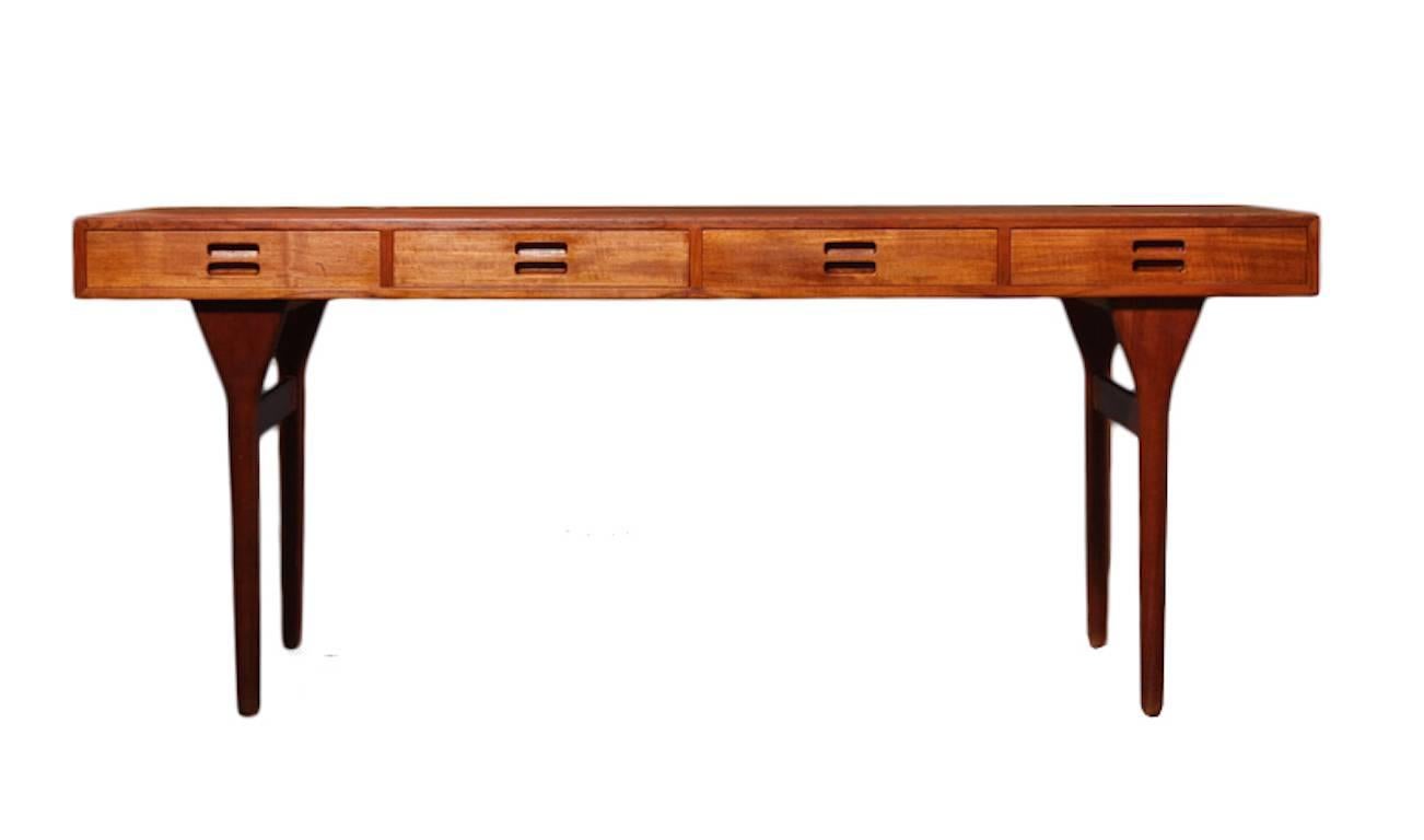 A teak writing desk by Nanna Ditzel for Søren Willadsen. This desk is truly a Danish design icon and one of Ditzel's most sought after designs. This model #93-4 desk is Danish design at it's best and showcases the simplicity and functionality of