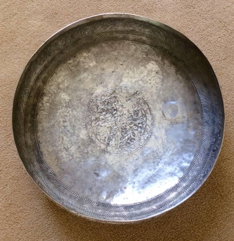 This finely drawn and worked shallow bowl resembles a shield from the underside, having a central motive that perhaps comes from the crest of a coat of arms.