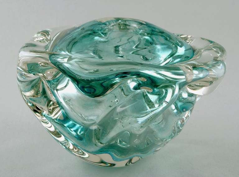 Andries Dirk Copier, hand blown turqoise-green art glass vase (Leerdam Unica), 1933-1934. This modern vase has an inner spherical form to which very thick colourless crystal glass has been applied. Then it was hand formed four times with a