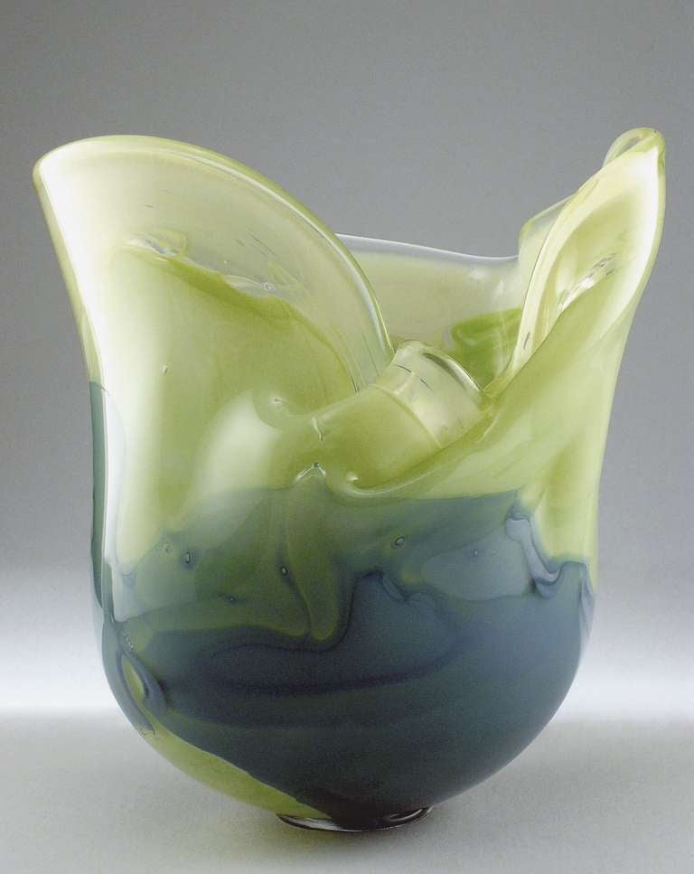 One-off studio glass vase in tints of green by Andries Dirk Copier, executed by glassblower Bernard Heesen. This vase was modified by hand to create the beautiful irregular organic forms and folds of the rim.
It is handblown and formed and has a