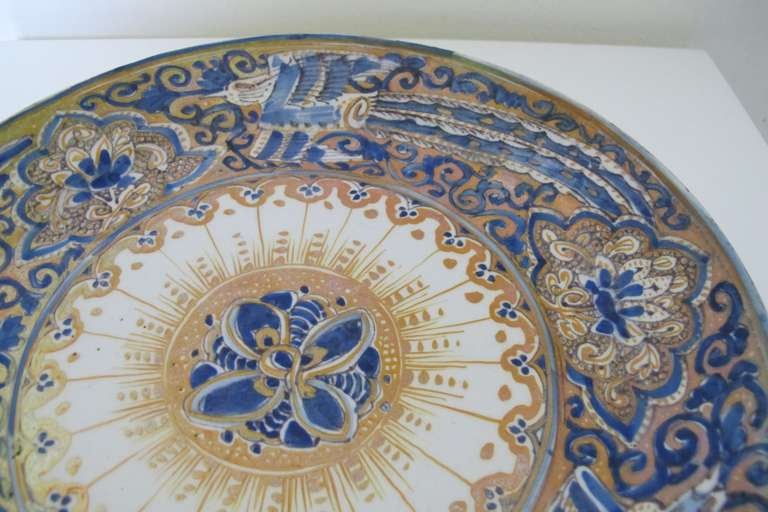 Unique plate with gold luster glaze, designed by Leon Senf, manufactured by Royal Delft Pottery firm De Porceleyne Fles, ca. 1912. This platter is a wonderful example of three colors New Delft ware with gold luster glaze. This is a complicated and
