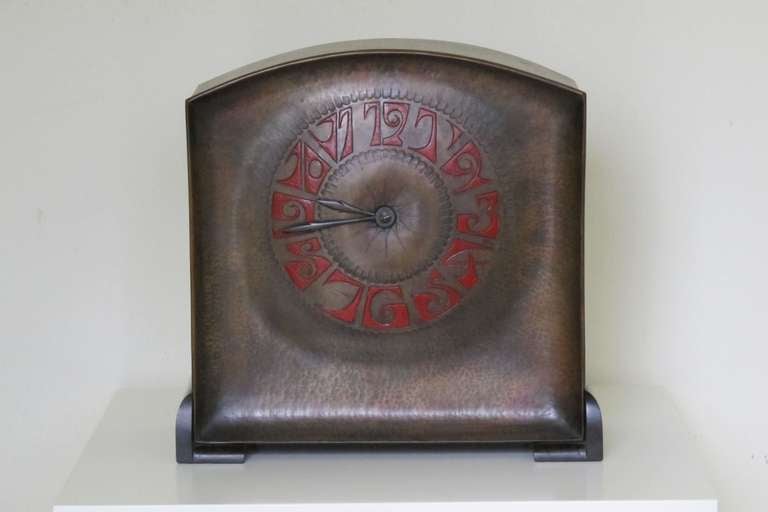 Art Deco pendulum in Amsterdam School style by Fons Reggers, circa 1925. The clock has a hammered brass cabinet, numbers made of red enamel and rosewood feet. The clock was a personal belonging of the Reggers family for many years.

The clock is