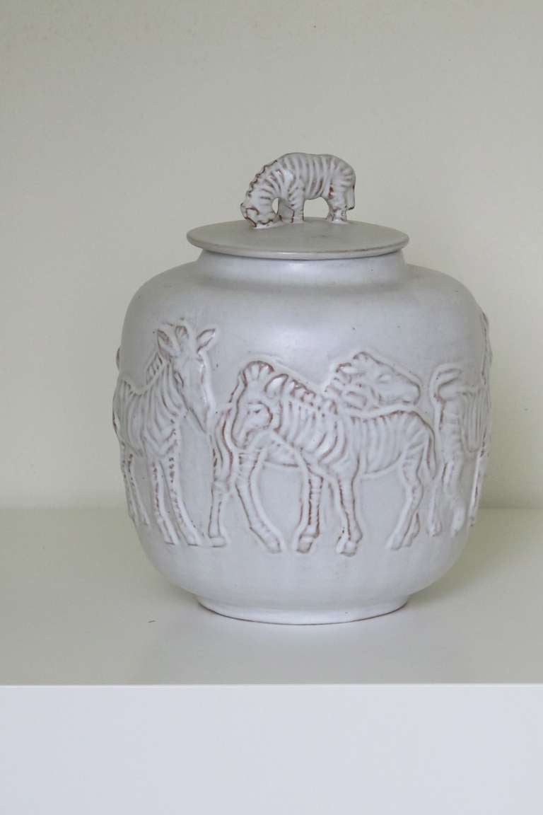Mobach Utrecht, grey glazed lidded pot with relief decoration of Zebras, 1950-1965. 

The Mobach pottery was founded in 1895. From the very start, the factory produced hand made modern earthenware. All ceramics are thrown on the wheel or shaped by