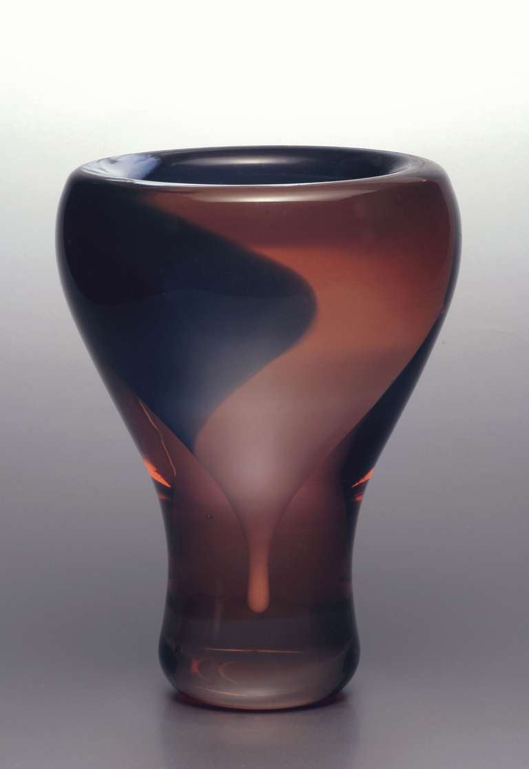 Thick-walled vase made of red glass with blue, opalescent and partly opaque white core. The vase has a robust rounded, swelling beaker shape. Designed by Andries Dirk Copier and blown at the Art Department of the Leerdam Glass Factory.

The
