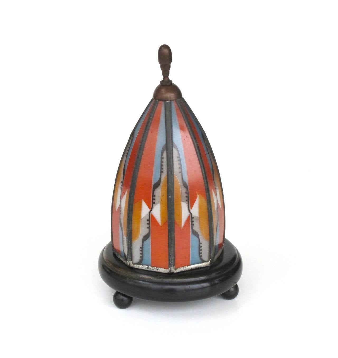 1920s Amsterdam School stained and leaded table lamp with wooden base and brass tip. Although the lamp isn't signed the shape and painted decor point out that the lamp was made by De Nieuwe Honsel.