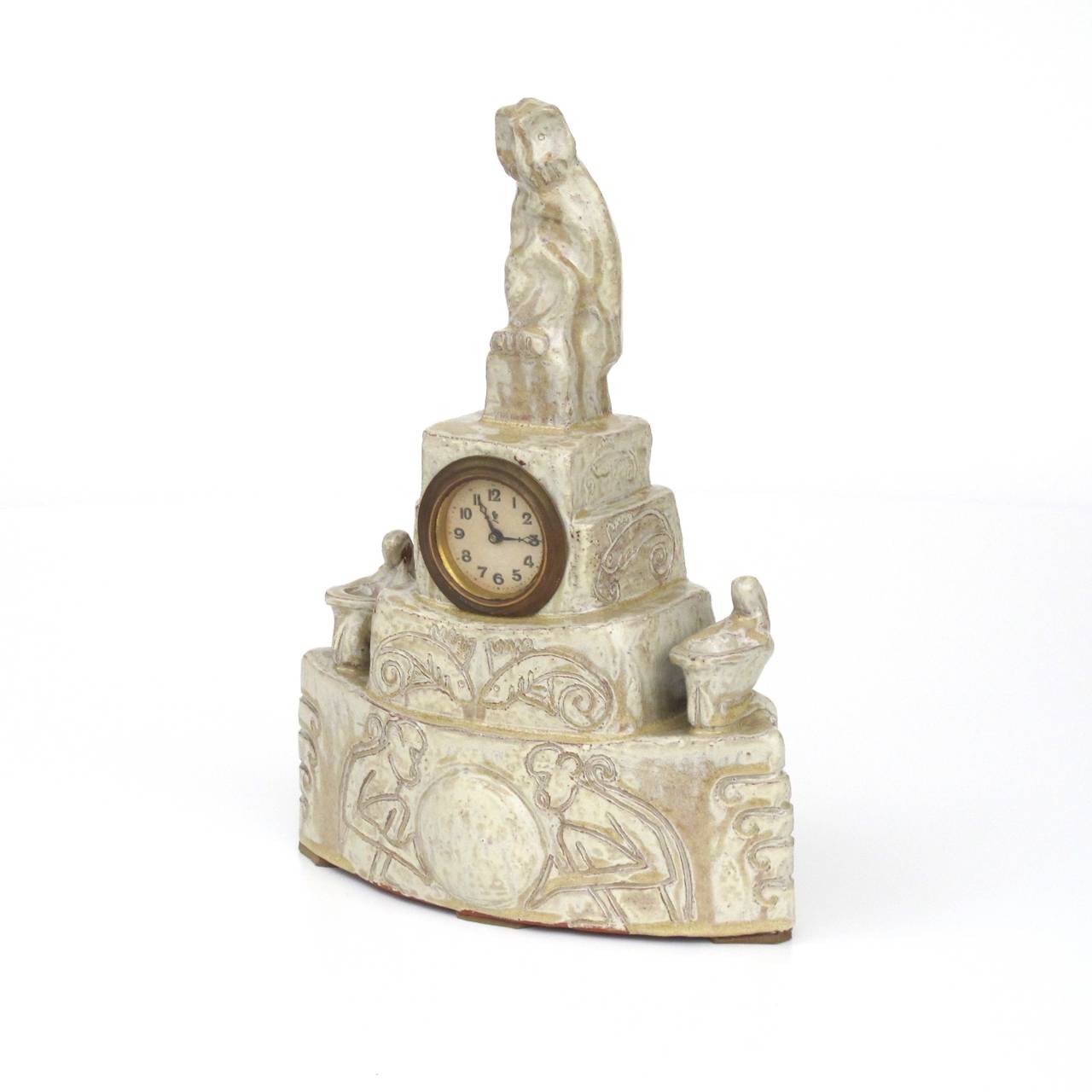 Intriguing Ceramic Mantle Clock, made by Cris Agterberg in his own workshop. The clock depicts sitting apes and typical Agterberg-fish with curls, is flanked by two fantastical figures and crowned by a sitting owl. The clock is in a good condition