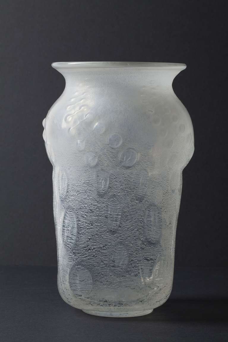 This one-off glass vase with tin crackle was made by Andries Dirk Copier in 1931-1932. It was mould blown into a special mould that resulted in vegetal relief forms, it was subsequently hand worked.
 
Andries Dirk Copier (1901-1991) was an