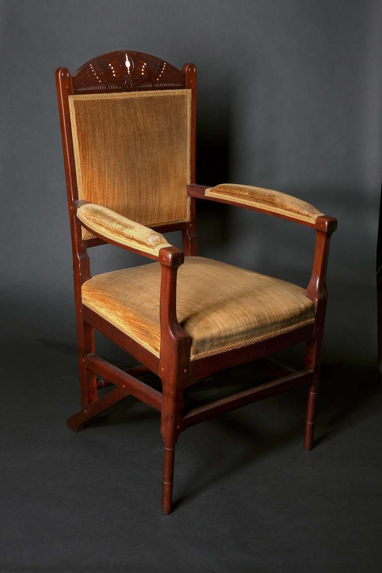 A great example of the inventive chair constructions that the famous Dutch architect Hendrik Petrus Berlage (1856-1934) designed in the early 20th century. The mahogany arm chair is decorated with wood carvings and inlays depicting a pair of