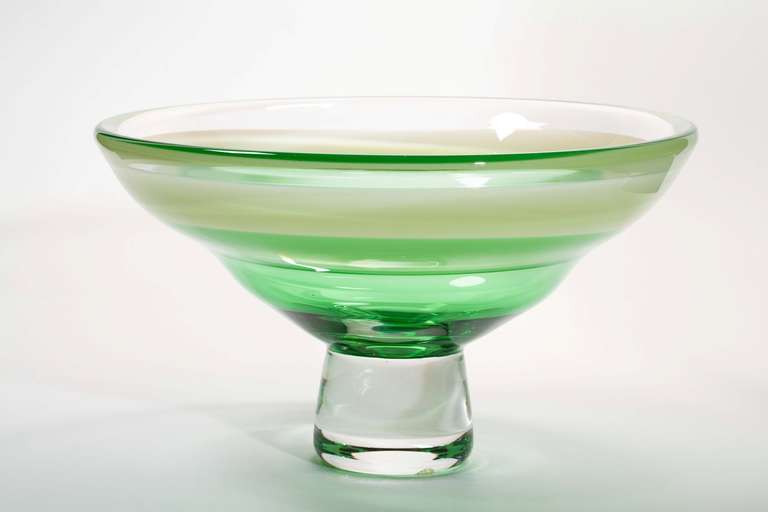 Glass bowl on foot in green tints by Floris Meydam. This one-off piece was produced at Glasfabriek Leerdam in 1977. It was blown by master glassblower Leen van der Linden. This excellent object is signed and numbered and in perfect