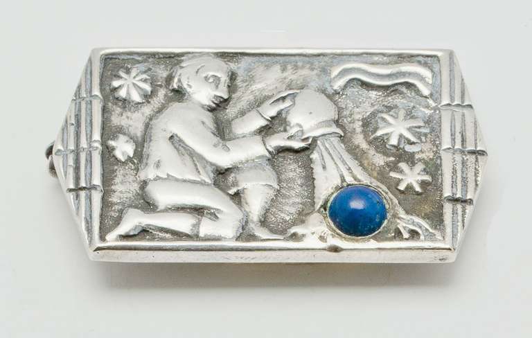Fons Reggers, silver broche with semiprecious stone, 1920s, Amsterdam. This crafty silver broche represents the horoscope Aquarius with a male figure pouring water from a jug.
 
Fons Reggers and his brother Rein Reggers came from a long lineage of