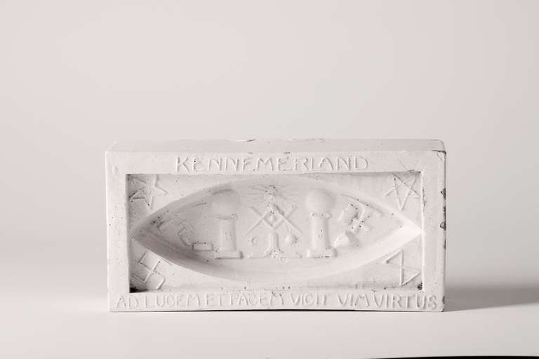 Chris Lanooy (1881-1948) was a Dutch potter and designer. Lanooy was commissioned by the Kennemerland Freemasons to make this decorative marker in the shape of a brick with different Freemasons symbols among others. For example: in the middle you