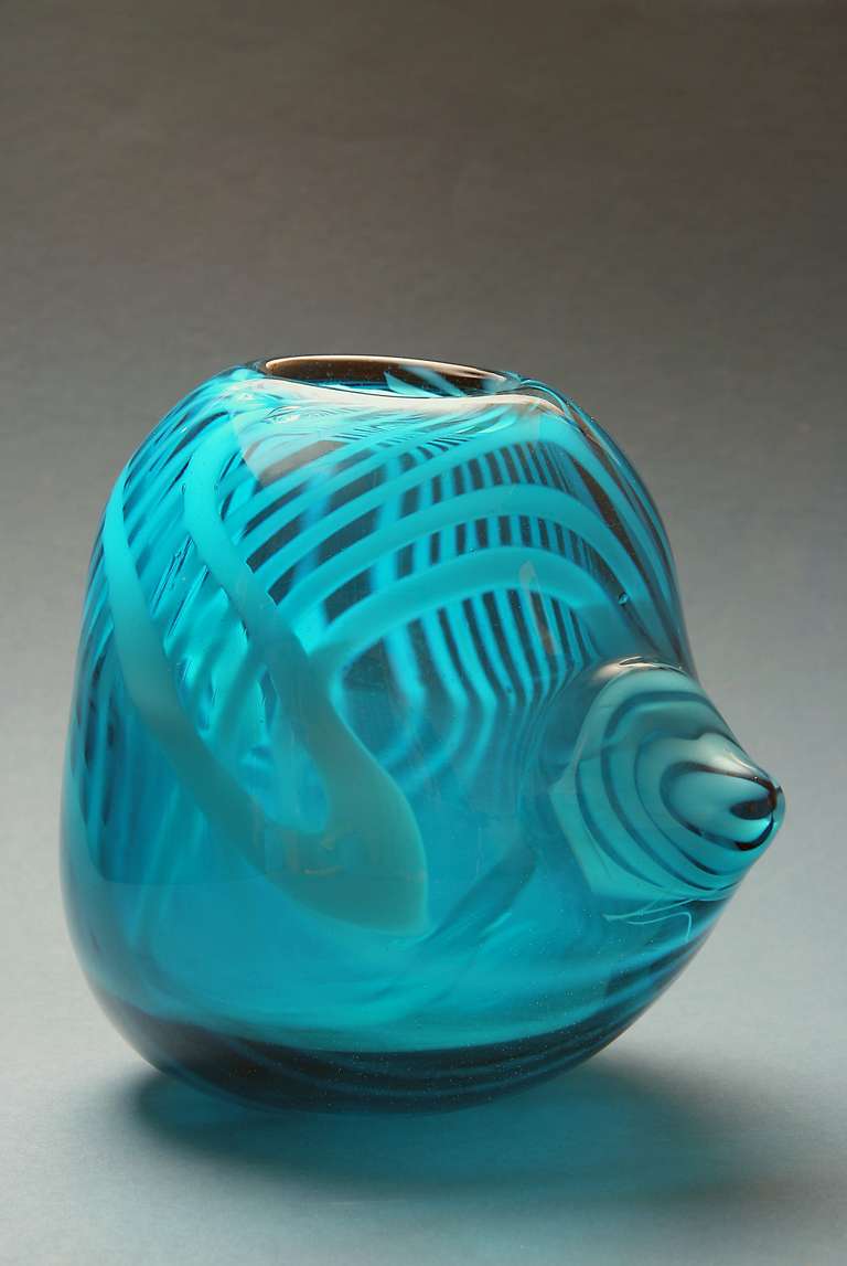 Thick turquois egg-shaped art glass object with spirals by Dutch glass artist Willem Heesen for Royal Glassworks Leerdam. Executed by master glass blower Arie van Lopik. The object is freely shaped and has a diamond-incised signature on the