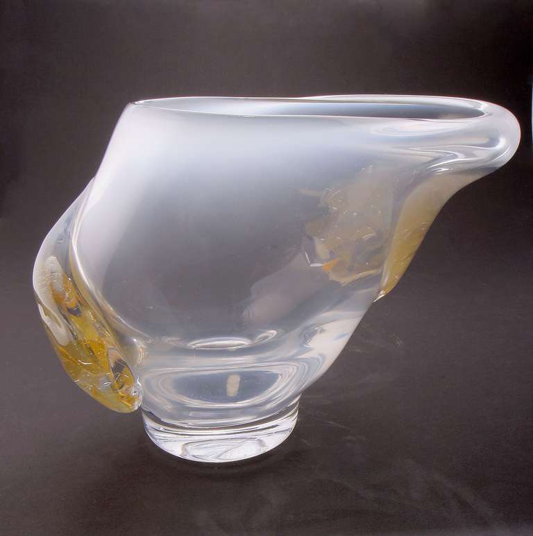 Beautiful Leerdam Unica designed by Sybren Valkema. Originally blown as a round vase, this object was stretched into an oval form. It is made of colorless glass underlayed with a thin layer of opal white glass. An appliqué of brownish, orange and