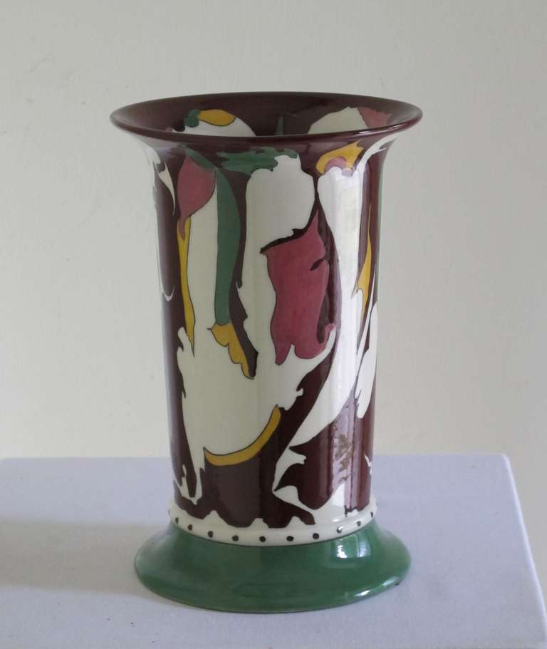 Art Deco vase with colourful pattern designed by Theo Colenbrander for Plateelbakkerij RAM (RAM pottery in Arnhem, The Netherlands). The pattern was handpainted on the earthenware vase by painter Jan Branger. It was manufactured in 1921 and signed
