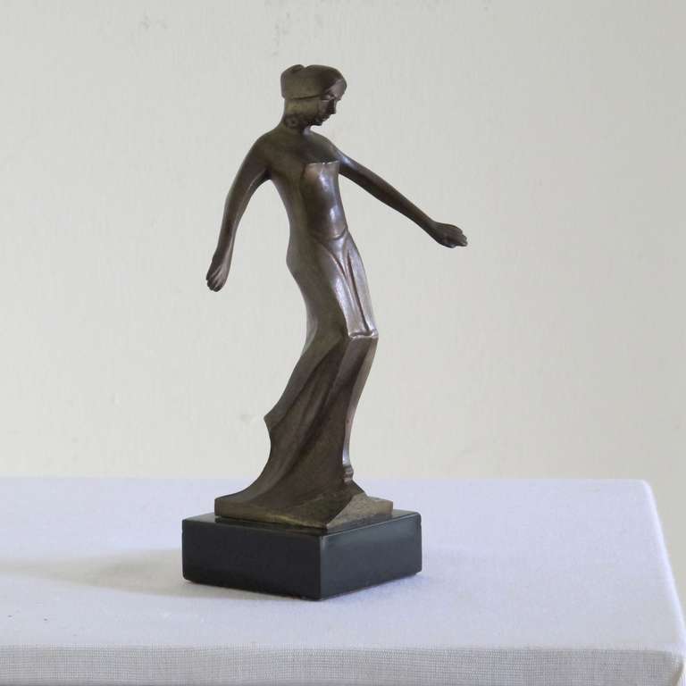 Cris Agterberg made this elegant bronze sculpture of a female figure in stylized forms. His monogram is engraved near her feet. 

Cris Agterberg (1883-1948) was a Dutch designer and maker of applied art (including ceramics) as well as a sculptor