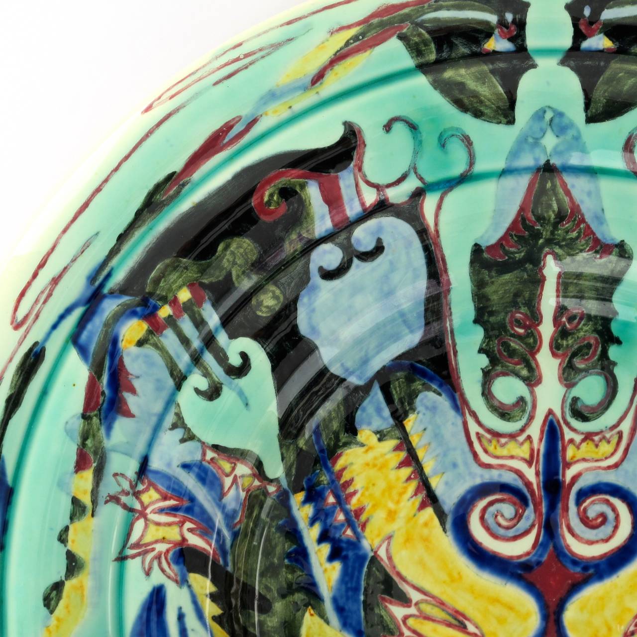 Stunning Art Nouveau wall plate by Theo Colenbrander for The Hague Plateelbakkerij Rozenburg. The symmetrically arranged but colorful and whimsical decor anticipates the Art Nouveau but remarkably also shows - although being designed over 25 years