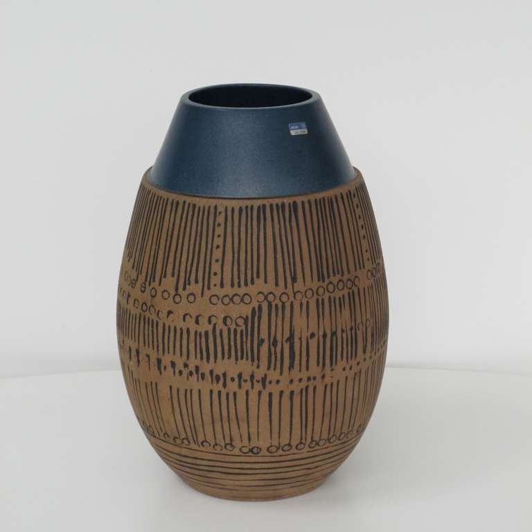 Mid-Century Modern vase by Lisa Larson for Gustavsberg, Sweden. The black incised over-all decoration of stripes and dots in red pottery is in contrast to the sober blue glazed edge at the top. It is signed "Gustavsberg" and "LL"