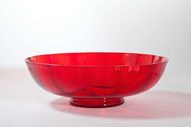 This beautiful red glass bowl by the famous 20th century glass artist A.D. Copier is an example of his early series-ware. The red variety is very rare. Red glass was valuable, because the Leerdam glass factory used gold to produce this colour. This
