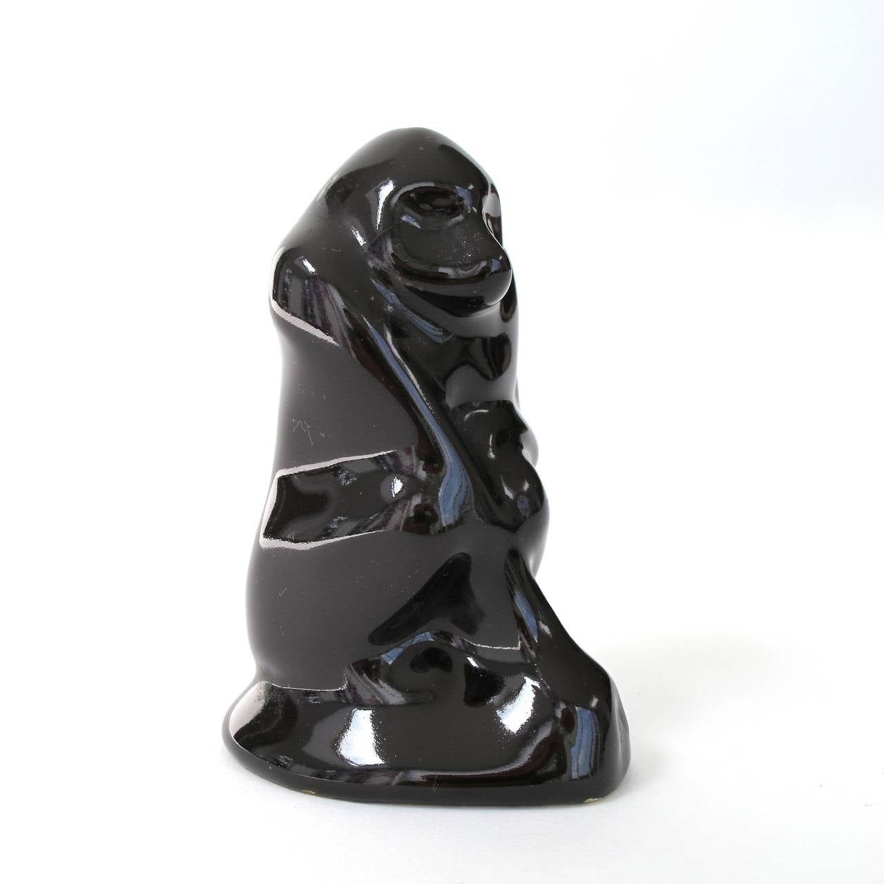 Fine and very rare black glazed earthenware sculpture of a seated monkey by Hildo Krop for the Dutch pottery manufacturer ESKAF. The piece is in an excellent condition and signed on the bottom with a manufacturer mark and the etched model numbers
