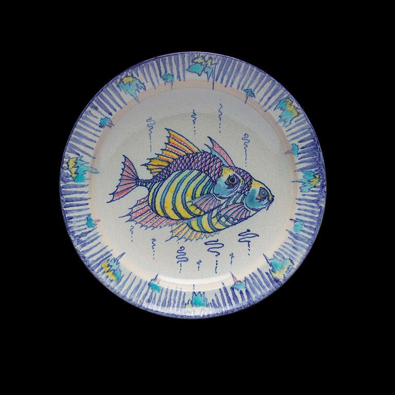 Ceramic plate with decoration of fish by Chris Lanooy, made in his own studio in Epe.  

Chris Lanooy (1881-1948) was a Dutch potter and designer. He was a self-willed man, a soloist with a strong urge to experiment. He worked for the Rozenburg