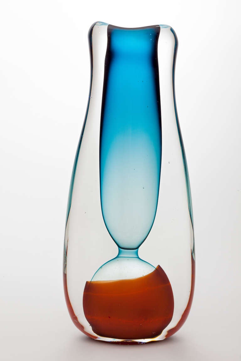 Free-blown and formed colorless glass by Floris Meydam with blue and orange inside. This one-off piece is signed and numbered.

Floris Meydam (1919 – 2011) has designed lots of glass objects for  the Leerdam Factory in the 1950s. His work was
