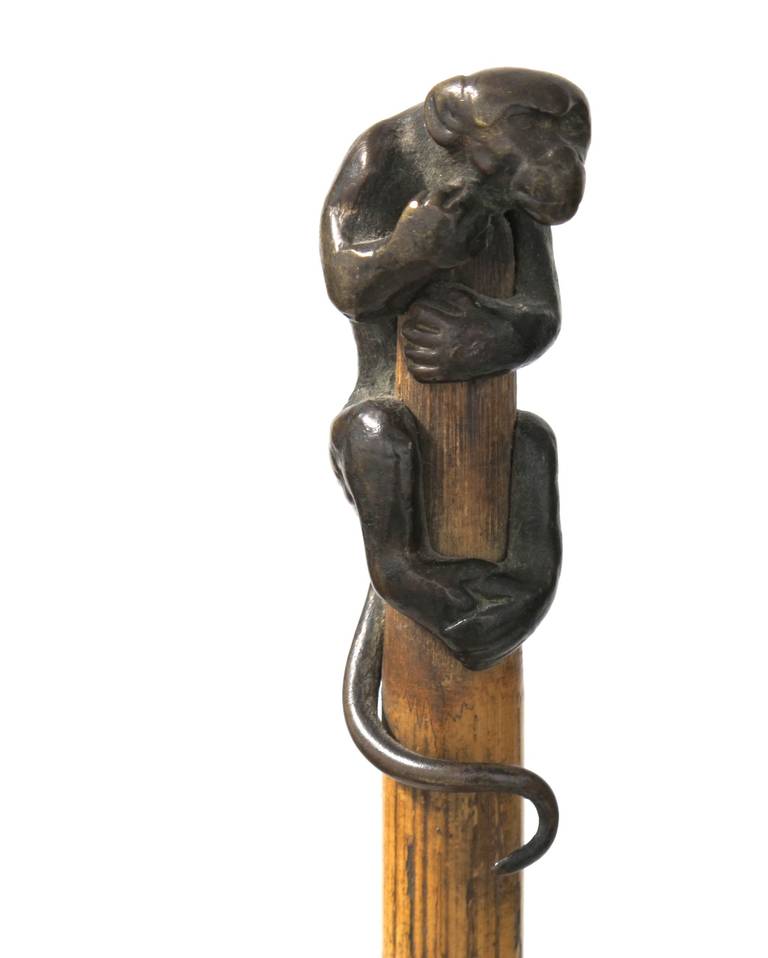 This original cane from the early 20th century is made of bamboo and has a solid bronze monkey as a handle. The animal figure, clearly depicting a monkey that's tightly clinging to the bamboo stick, is well modelled and shows excellent