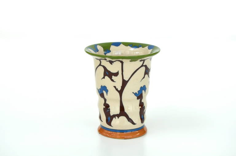 Art Deco Beaker shaped Vase with colorful pattern designed by Theo Colenbrander for Plateelbakkerij Ram (Ram pottery in Arnhem, The Netherlands). The pattern called Rank (Tendril) was hand-painted on the earthenware vase by painter Willem Elstrodt.
