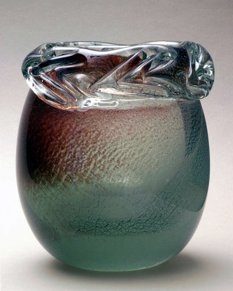Glass Unica by Andries Dirk Copier. Signature in the pontil mark, diamond-incised “Leerdam-Unica” S 527 A.D. Copier. 

Heavy colourless glass, a copper compound fumed on to the interstitial layer, which has fine crazing after inflation and assumed