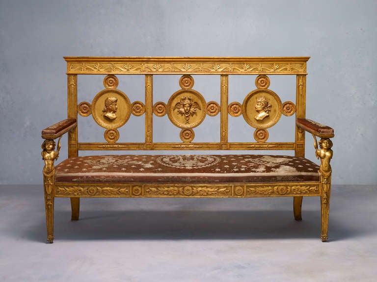 A rare and important Neapolitan Empire giltwood settee. Reupholstered with the original fabric.