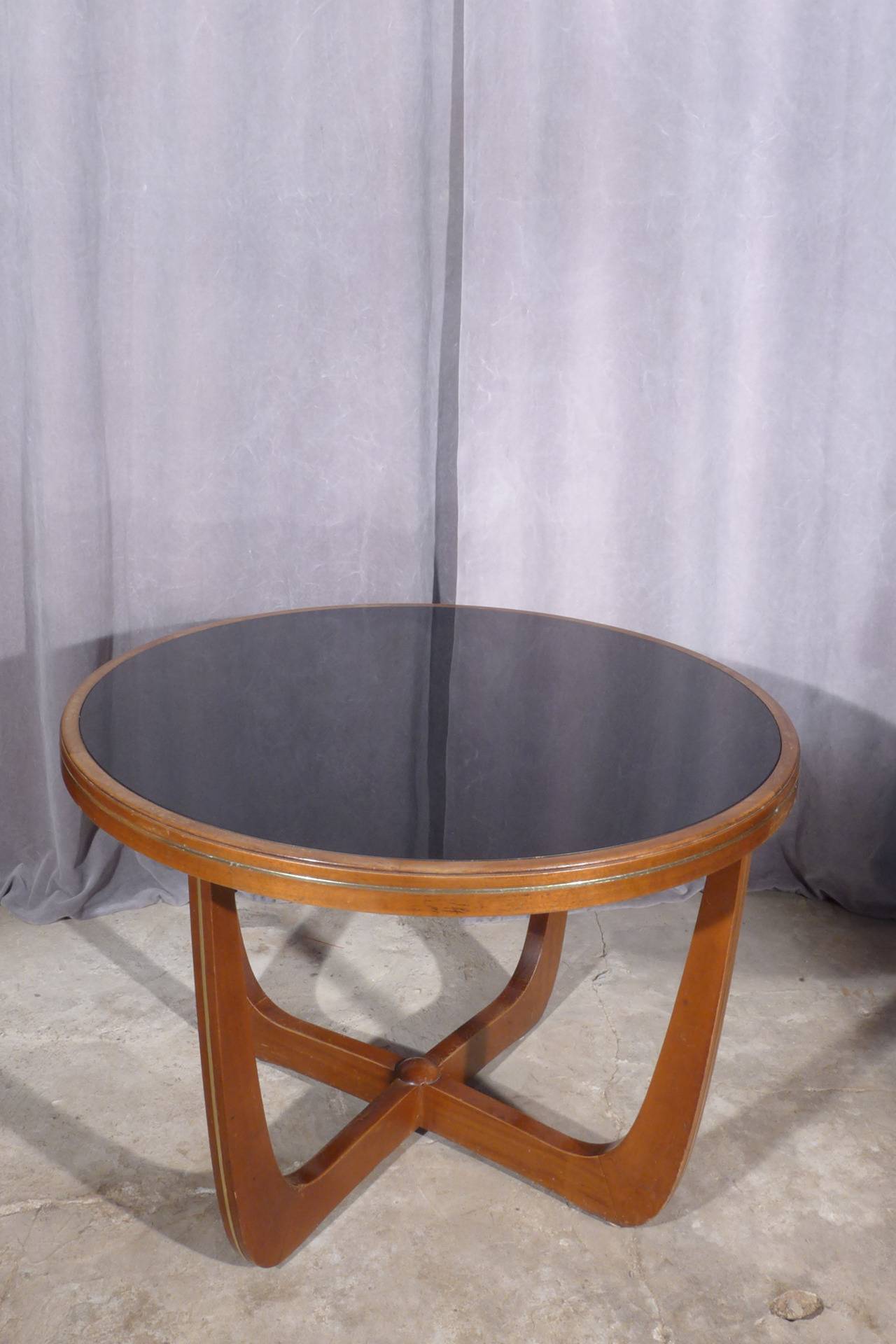 An Italian mahogany and black glass side table.