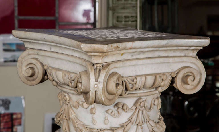 This is a beautiful carved white marble column or pedestal with ionic capital and swag motif, from the early 1900s. It was salvaged from a building at East 93 St. and Madison Ave. in New York City. It's mate was not able to be salvaged. This can be