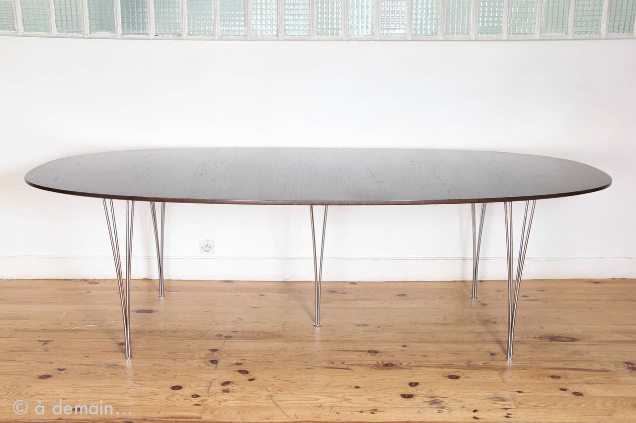 The story tells that Piet Hein got this table idea from a traffic problem in Stockholm, or rather from its solution: a super elliptical roundabout. 

Beautiful harmonious and large oval table that is supposed to be democratic because everyone can