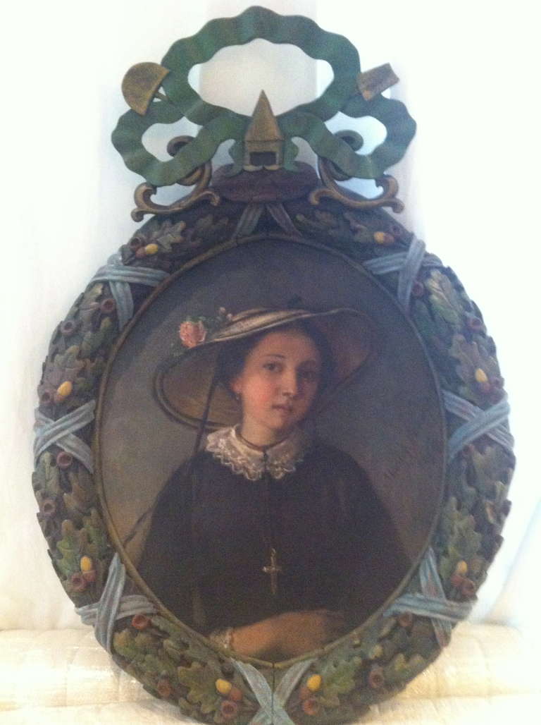 Mary Verdier, 1854

Ravishing oil painting on canvas  of a young lady wearing a straw hat, signed mary Verdier, 1854, on the bottom right of the picture.
It is framed by the most romantic composition of ribbon, oak leaves and acorns, in carved