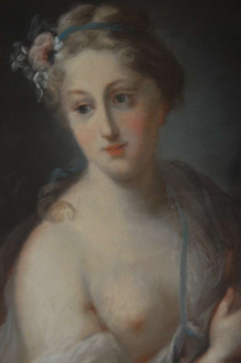 Pastel on canvas representing a bust of woman holding a laurel wreath. Very delicate rending of the folds in the silk dress, and a lovely hair arrangement of flowers. 
This pastel is unsigned, but dates from the 19th century. It is drawn after the