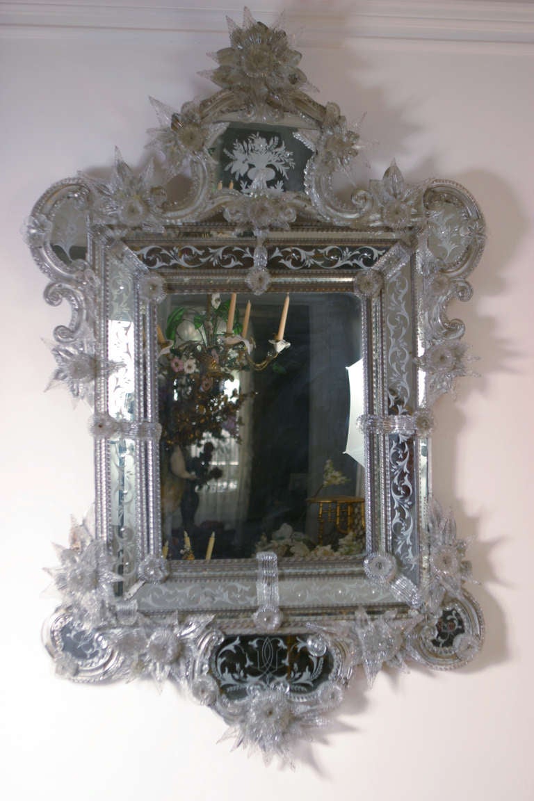 A beautifully ornate, large, 19th century venetian glass mirror.  This exquisite and very decorative piece, has been cleaned and is not the usual ''yellowish'' tint, but a soft grayish.