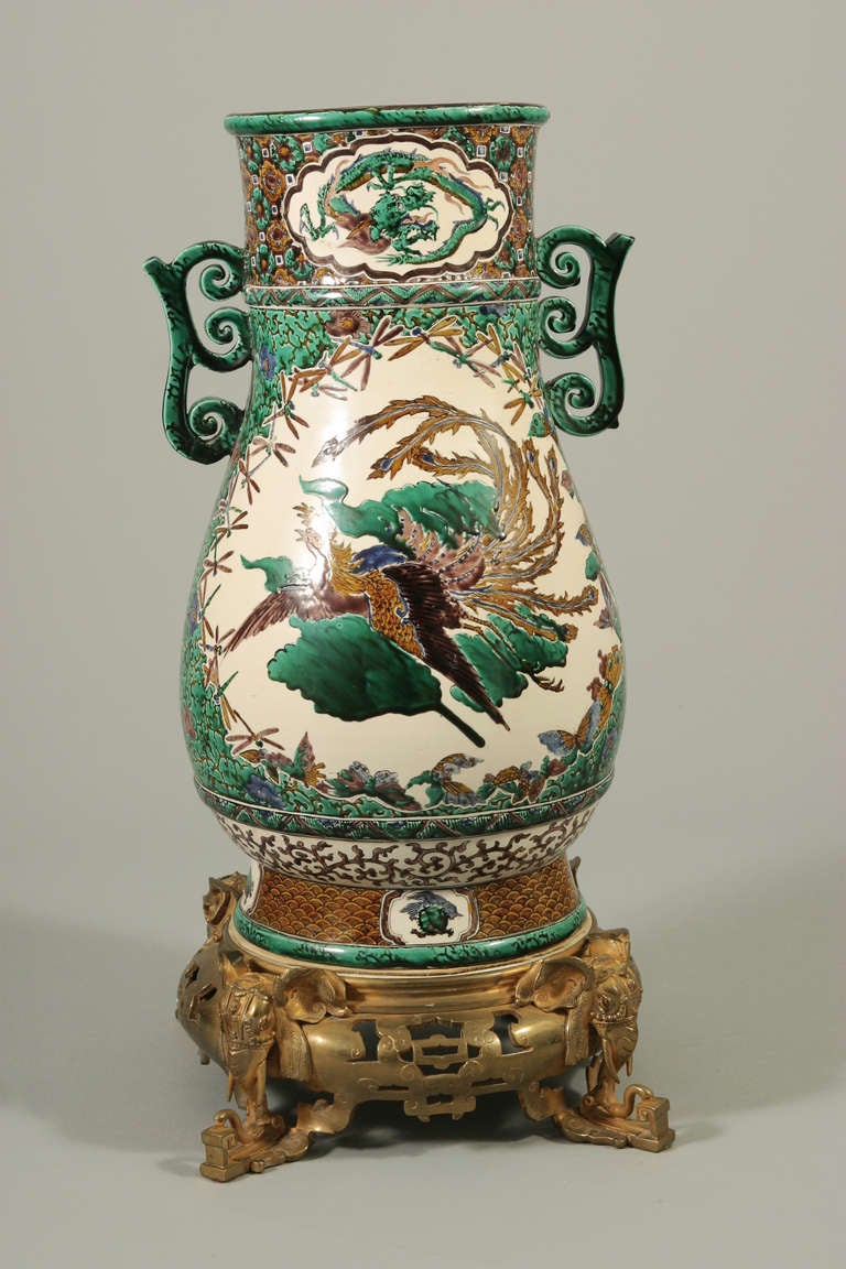 Japanese Porcelaine, Kutani

Important Kutani porcelaine vase ,the green yellow and brown ground adorned by a central motif of a dragon and phoenix surrounded by butterflies and dragonflies. The base in chiseled gilded bronze, resting on four
