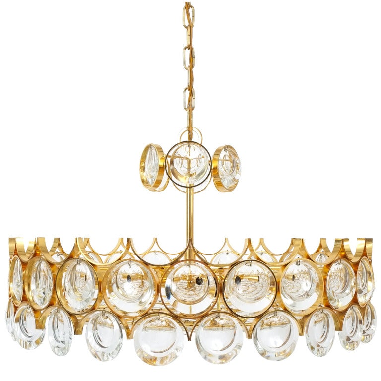 Outstanding pair of gold-plated chandeliers by Palwa.  Stunning yet minimalistic design executed with a taste for excellence in both craftsmanship and style. This chandelier is larger than the regular mid-sized ones measuring 22