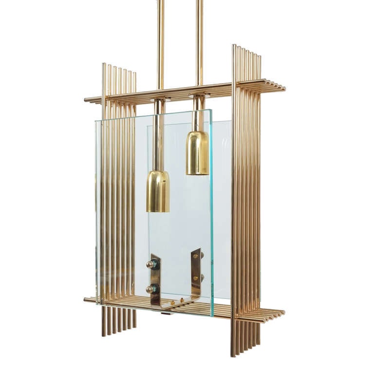 Elegant fixture featuring two rectangular clear glass screens attached to a  delicate gilded brass cage. The light is in excellent condition. The brass cage and hardware have been newly gold-plated. It holds two bulbs with 40w each and has been