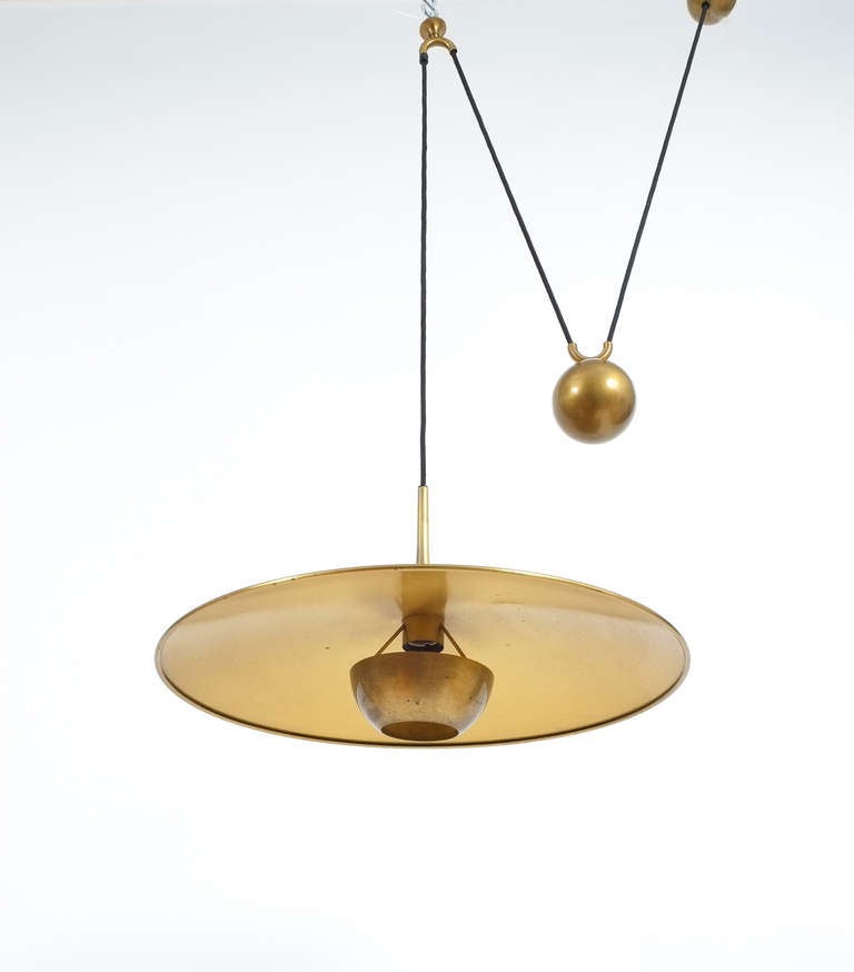 Elegant brass pendant from Florian Schulz/Germany. Very well made piece with a matt brass finish and a heavy counterweight to easily adjust the light in height.
The condition is very good with minimal patina, it holds one bulb with a max. of