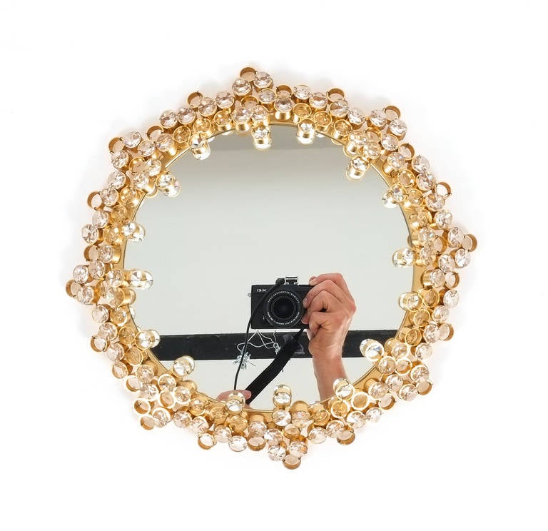 Beautiful petit golden crystal mirror by Palwa from the 1960s executed with great attention to detail, consisting of hundreds of gilded brass rings encrusted with crystal. The mirror is in excellent condition. We have matching lights available also,