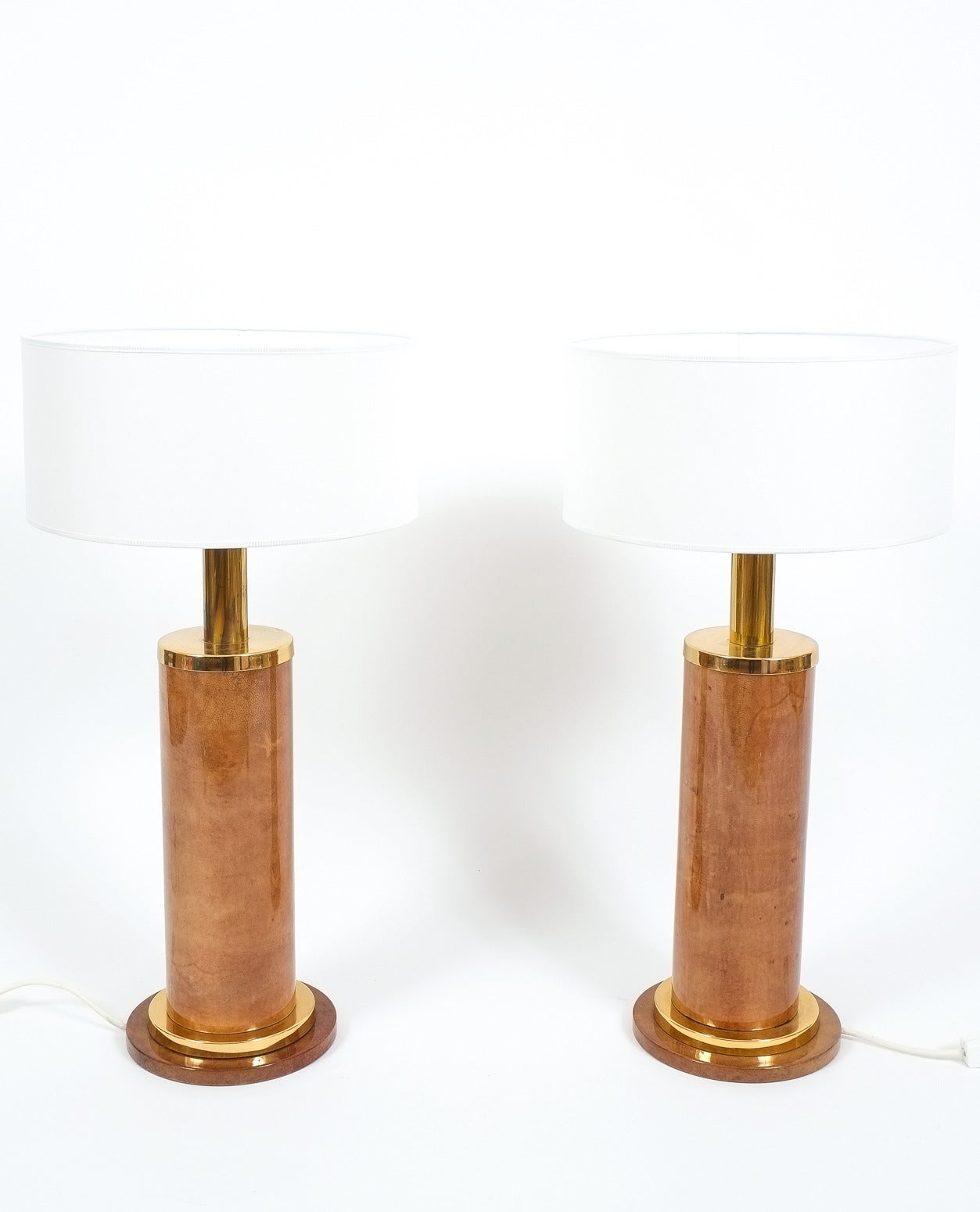 Aldo Tura pair of large table lamps parchment, Italy, circa 1960. Rare pair of rare Aldo Tura table lamps in excellent condition. Composed of dyed parchment each light holds a single large bulb with 75W max. The parchment and brass are in excellent