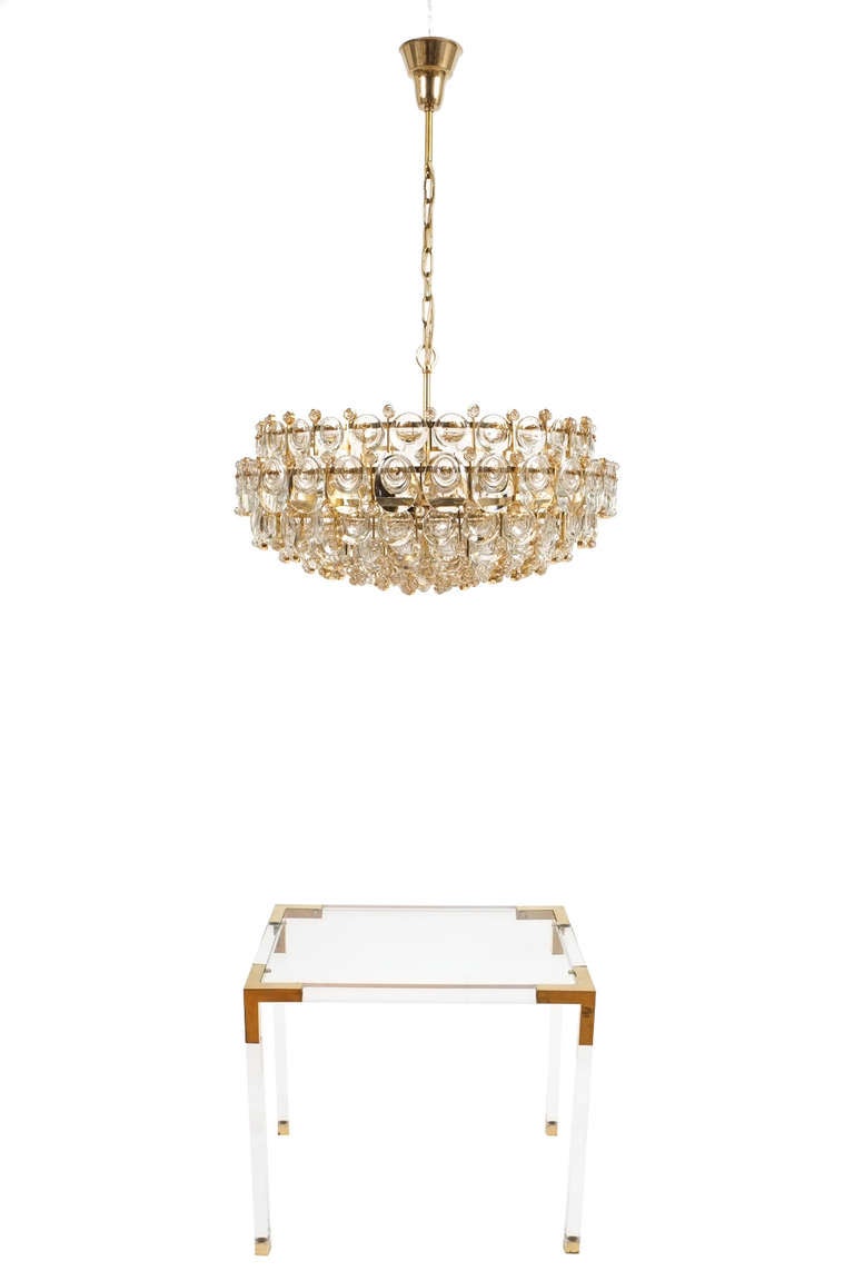 Glamorous and very large 28” multi-tiered chandelier by Palwa with hundreds of smooth crystals in different sizes. Handmade gold plated light with ten bulbs illuminating this stunning chandelier. It has been restored, rewired and can be used with a