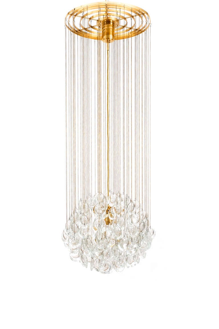 Stunning ball chandelier by Palwa. Smooth Jewel-like crystals hanging from a multitude of delicate brass chains. 
The fixture has been professionally cleaned and polished and newly rewired.